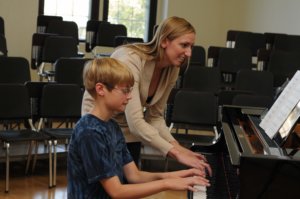 Jennifer teaching Aiden at the piano