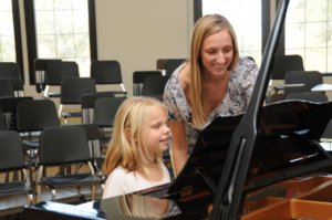 Jennifer teaching Olivia at the piano