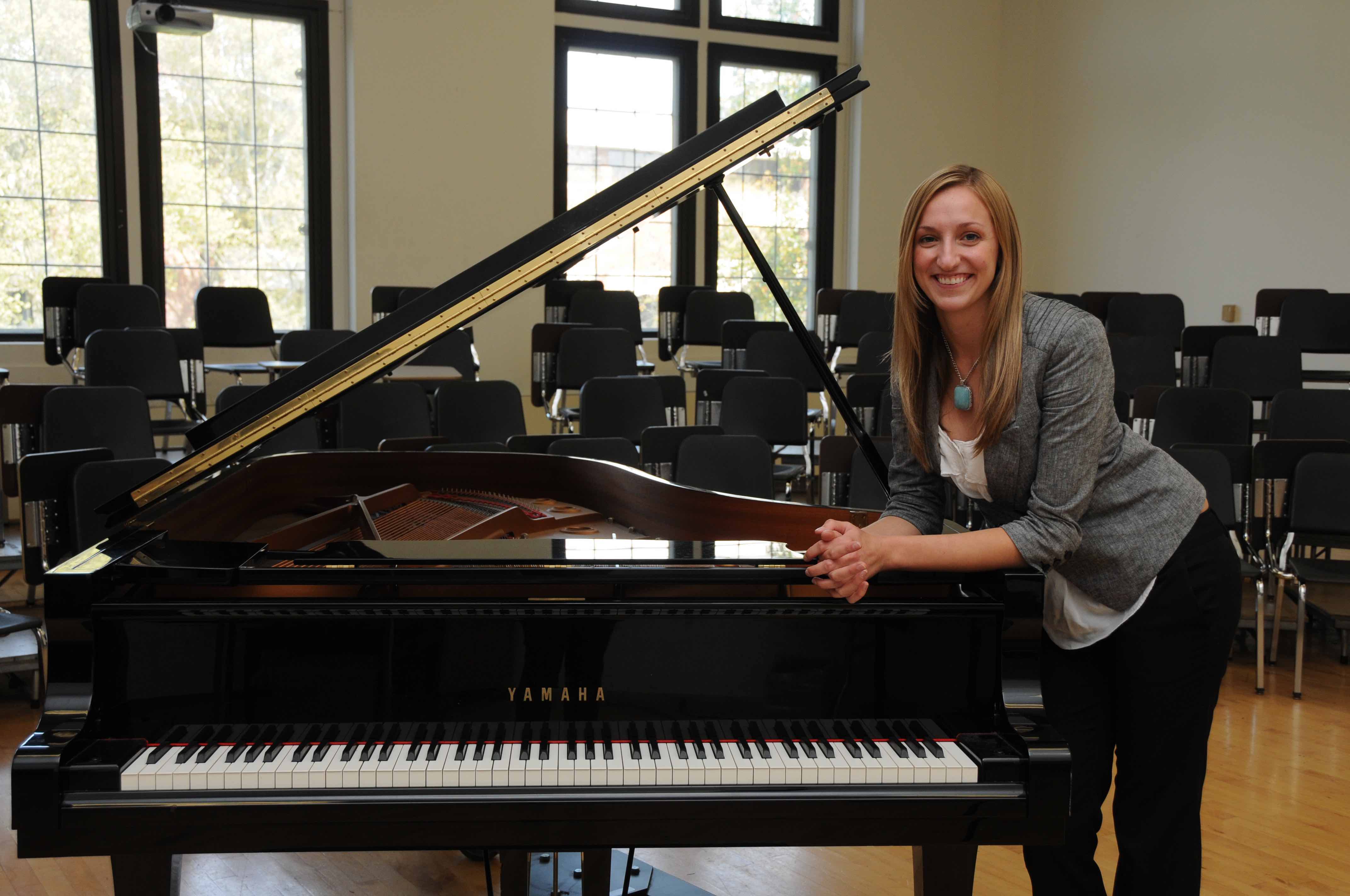 Jennifer Stadler leaning on piano